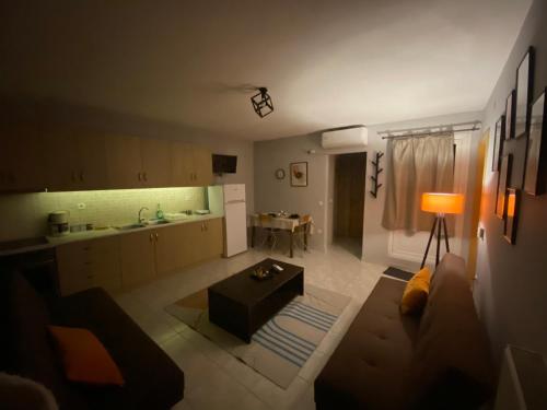 a kitchen and a living room with a couch and a table at Cozy house in Xanthi