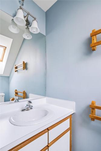 a bathroom with a sink and a mirror at Highridge B14 Enjoy the view ski back trail shuttle service sports center in Killington