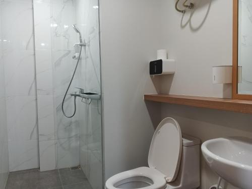 a bathroom with a shower and a toilet and a sink at Peaceful Sea view Cozy APT at Batam Center - By MESA in Batam Center
