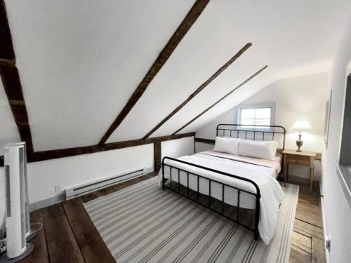 a white room with a bed and a desk at Historic Estate - 5 min to Mohawk Mt Ski Resort 