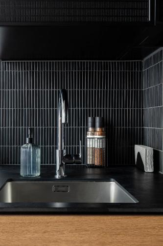 a kitchen sink with a faucet on a counter at Stylish loft with terrace Paupys, Old town in Vilnius