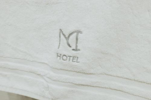 a white mattress with the letter n on it at MCI HOTEL in San Juan de los Lagos