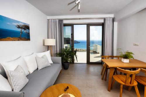 a living room with a couch and a table at "Thea" Luxury Apartments with great View in Plakias