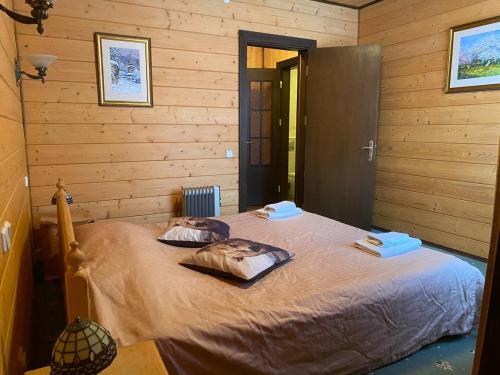 a bedroom with a bed with two towels on it at Vilni Vitry in Osmoloda