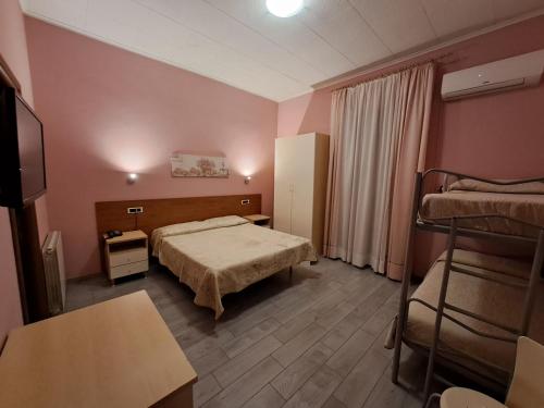 ジェンツァーノ・ディ・ローマにあるHotel Villa Robiniaのベッド2台とテレビが備わるホテルルームです。