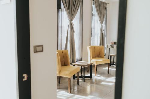 a room with two chairs and a table and a window at MCI HOTEL in San Juan de los Lagos
