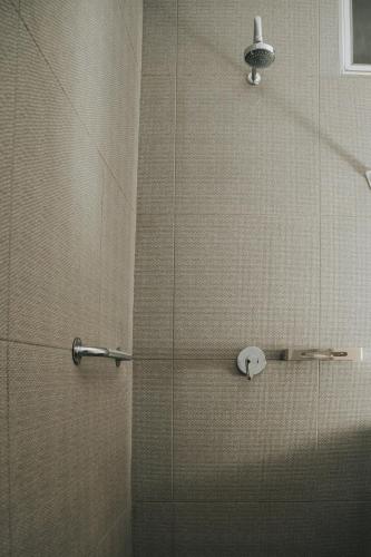 a shower with a glass door in a bathroom at MCI HOTEL in San Juan de los Lagos