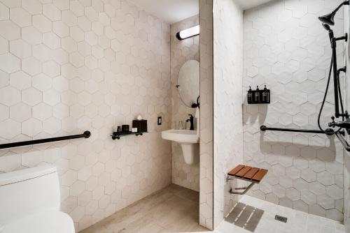 a white bathroom with a toilet and a shower at Esme Miami Beach in Miami Beach