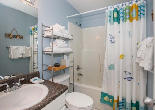 a bathroom with a toilet and a shower and a sink at Grand Caribbean 420 by ALBVR - Great condo and views that won't break the bank. Must see! in Orange Beach