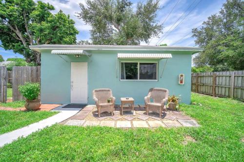 a blue house with two chairs and a table at Blue Wave Bungalow - 1 1 - Stylish in Dania Beach