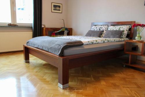 a large bed in a room with a wooden floor at CENTRUM PANORAMA STUDIO Złota 81 Street Warsaw by Gi4 in Warsaw