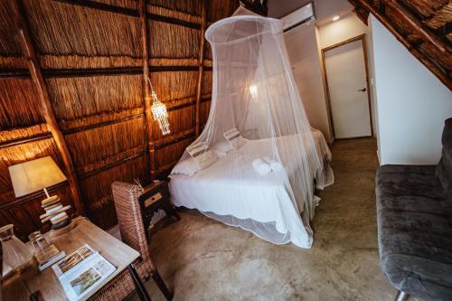 a bedroom with a bed with a wedding veil at Namaste Beach Club & Hotel in Tierra Bomba