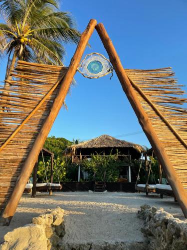 a view of a resort with a palm tree at Namaste Beach Club & Hotel in Tierra Bomba