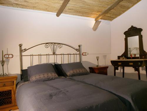a bedroom with a bed and a wooden ceiling at Can Pavet in Pontons