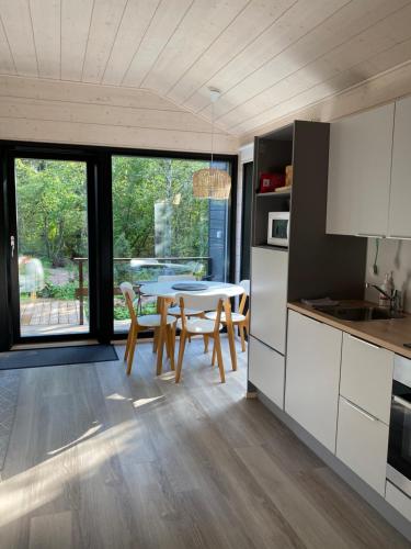 a kitchen and dining room with a table and chairs at Tammikon Tupa in Tuusula