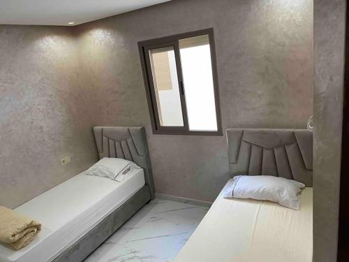 En eller flere senge i et værelse på Appartement sala al jadida