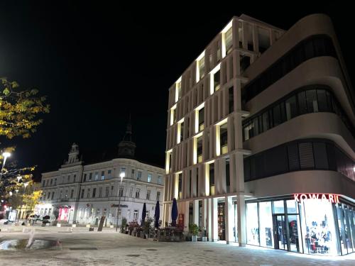 a building on a city street at night at Luxury Apartment Villach City in Villach