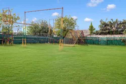 a gym with nets on a grass field at Palette - JPS Residency in Gurgaon