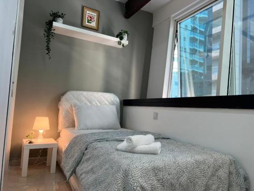 a bedroom with a bed and a window at Partition Room With Window Near MOE Metro in Dubai