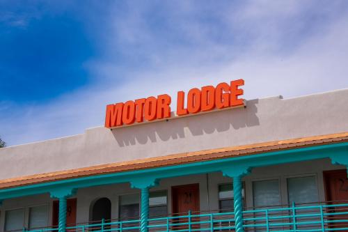 a sign on the top of a motel at Taos Motor Lodge in Taos