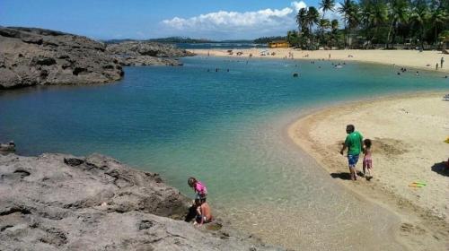 a group of people playing in the water at a beach at Villahouse3 in Vega Baja