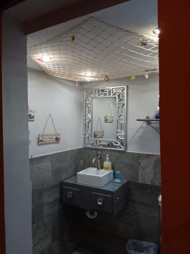 a bathroom with a sink and a mirror at Villahouse3 in Vega Baja