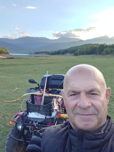 a bald man is standing in front of a motorcycle at HOTEL ΗΩ (ΞΕΝΩΝΑΣ ΤΣΙΑΧΡΗΣ) in Morfovoúnion