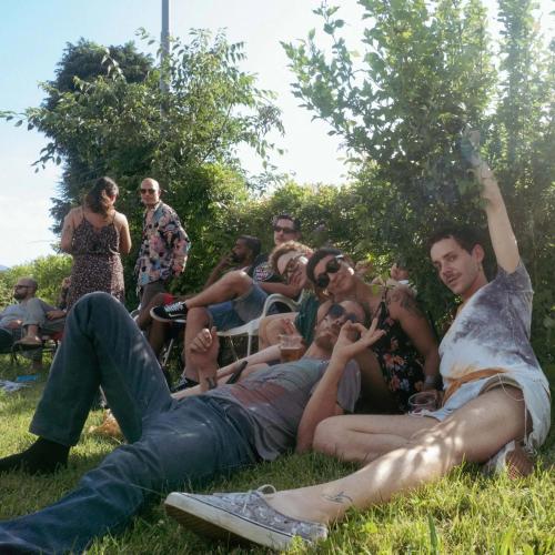 a group of people laying in the grass at Ostello La Salana in Capannori