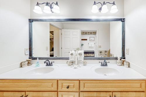 a bathroom with two sinks and a large mirror at Atlantis Bliss Haven in Saint Augustine Beach