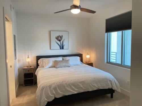 a bedroom with a large bed with a ceiling fan at Seahorse 316 in Sarasota
