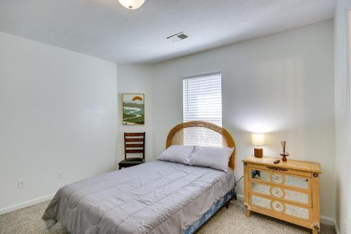 a bedroom with a bed and a dresser and a window at Quaint Orangeburg Townhome Near Hospitals and Campus in Orangeburg