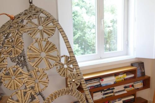 a wooden decoration hanging in front of a window at Le Raisonnable in Porto