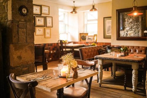 a restaurant with tables and chairs in a room at Craigellachie Hotel of Speyside in Craigellachie
