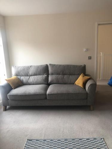 a gray couch sitting in a living room at Quirky and spacious in Lawley Bank