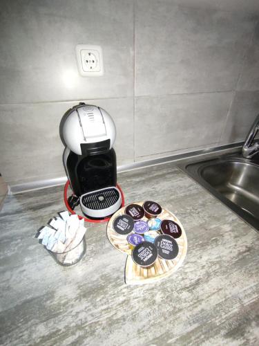 a coffee maker sitting on a counter next to a sink at Sea View Apartments Nikos in Néa Péramos