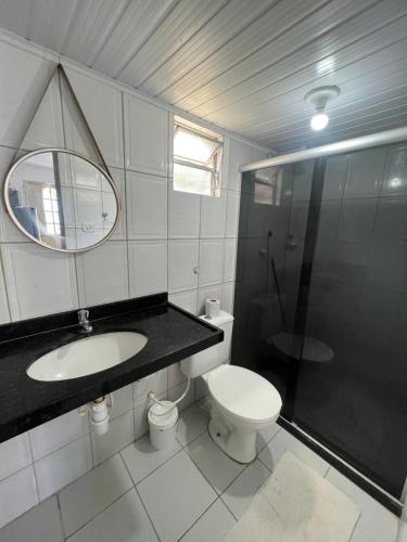 a bathroom with a toilet and a sink and a shower at Village Galés de Maragogi in Maragogi
