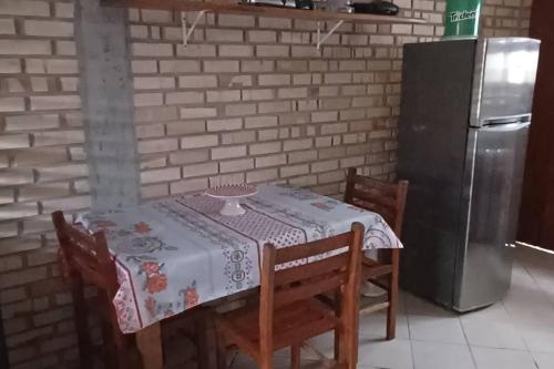 a kitchen with a table and a refrigerator at Sobrado praia cachoeira in Florianópolis