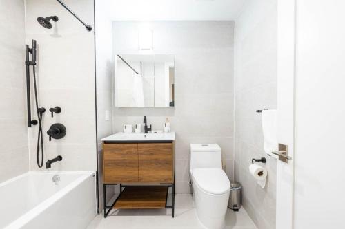 a white bathroom with a sink and a toilet at 149BK-202 NEW Condo 1BR IN PRIME GREENPOINT BK in Brooklyn
