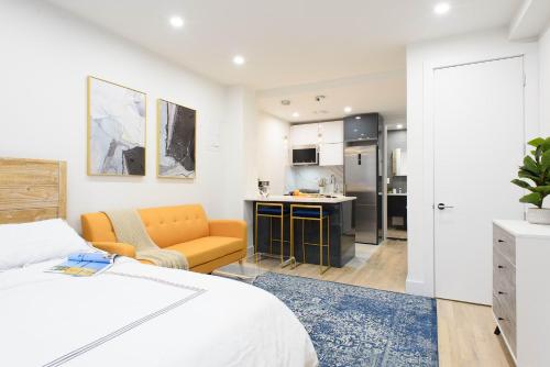 a white bedroom with a bed and a kitchen at 1597-12 NEW Studio Prime UES WD in unit in New York