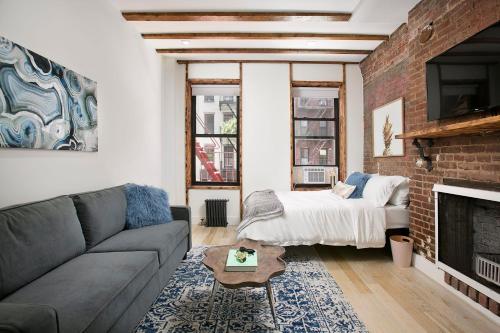 ein Wohnzimmer mit einem Sofa und einem Bett in der Unterkunft 24-6 Gramercy area Newly reno Studio W D in unit in New York