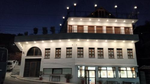 een wit gebouw met lichten erop bij Hotel Bebej Tradicional in Gjirokastër