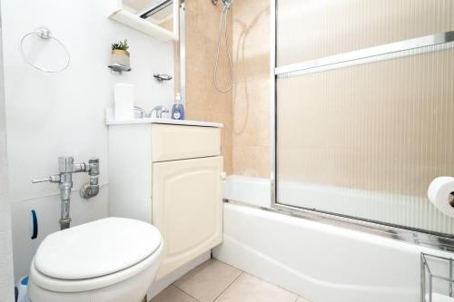 a bathroom with a toilet and a shower at 350-GA Spacious Studio Gramercy Sleeps3 in New York
