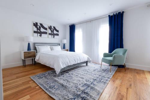 a bedroom with a bed and a blue chair at 323-2 Specious 2BR Williamsburg in Brooklyn