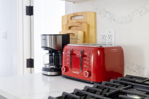 a red toaster sitting on a counter next to a coffee maker at 323-2 Specious 2BR Williamsburg in Brooklyn