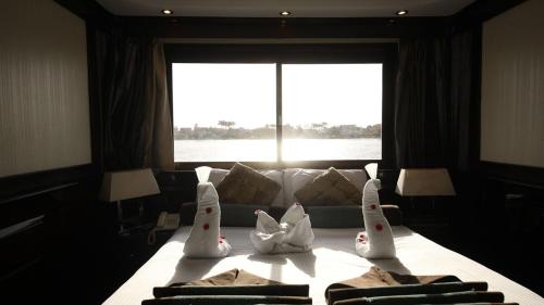 a room with a bed with four rabbits on it at مركب ريفر River Boat in Cairo