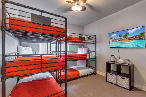 a bedroom with four bunk beds in a room at Paradise Village at Zion 28 Private Hot Tub, Outdoor firepit, and Community Pool in Santa Clara