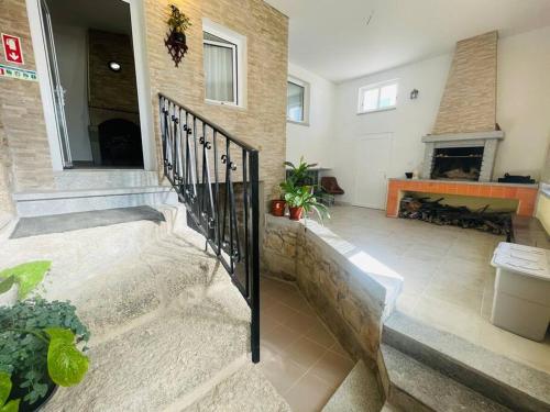 a living room with a staircase and a fireplace at Casa rural Safurdão in Safurdão