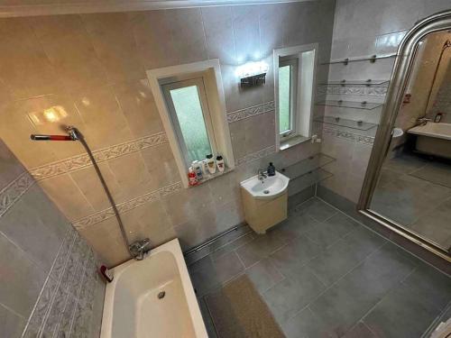 a bathroom with a toilet and a sink and a mirror at Villa Livslust Trollbäcken uthyrning pågår in Tyresö
