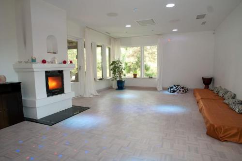 a living room with a couch and a fireplace at Villa Trollbäcken med bastu, värmegolv, öppen spis in Tyresö