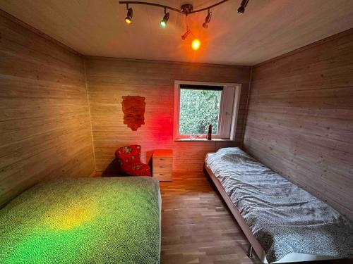 a bedroom with a bed and a window in it at Villa Trollbäcken med bastu, värmegolv, öppen spis in Tyresö